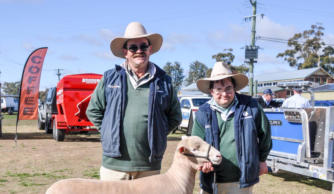 LIKE FATHER, LIKE SON: Gordon and Tom Close, Closeup, Finley, with the ewe Tom has led in the judging ring.
