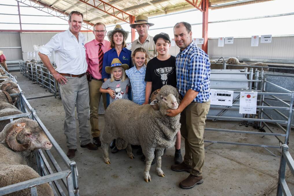 Auctioneer Paul Dooley, Elders agent John Newsome, South Australian buyers Allison, Craig, Yasmin, Kelsey and Lachie Stott and vendor Jock McLaren and the charity ram that sold for $3000. 