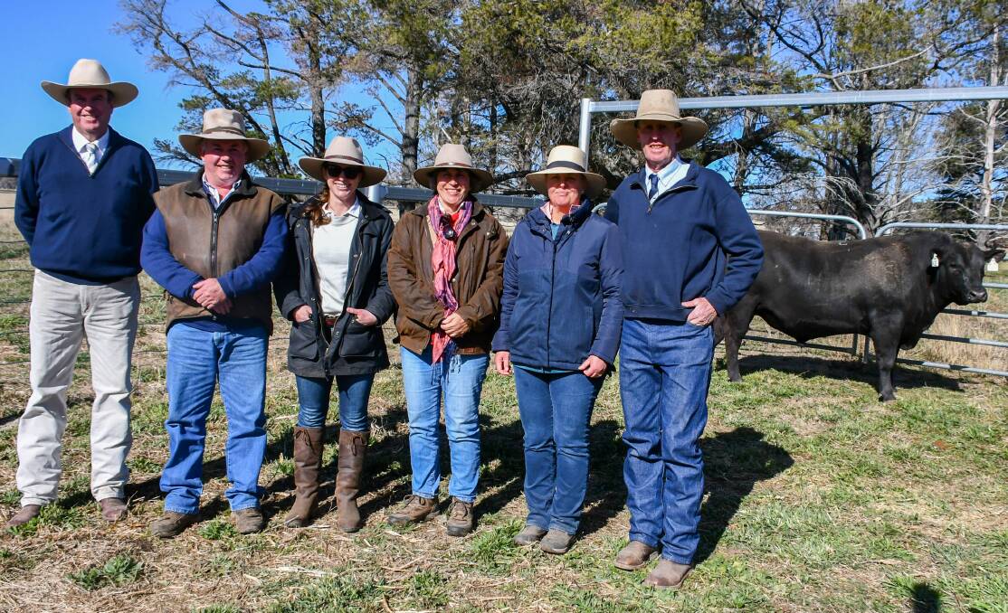 Auctioneer Paul Dooley, PR Watts Armidale agent Tony Frizell, buyers Tracey and Joanne Gowen, and vendors Sally and Andrew White with the $14,000 top price bull. 