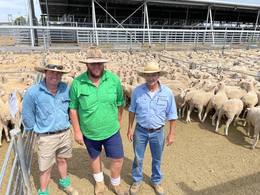 The $350 top-priced pen of ewe lambs were sold by Kevin and Jayne Norrie, Allambie, Girral. The ewes are with the Norries' son Liam; farm manager Joel Wallis and KMWL agent Matt Lennon, Forbes. Photo: Karen Bailey