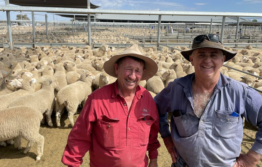 Forbes Livestock and Agency Company director Tim Mackay with Garry Penfold, Emohruo, Quandialla, who sold prime lambs for $120 a head at Forbes on Tuesday. Picture by Karen Bailey.