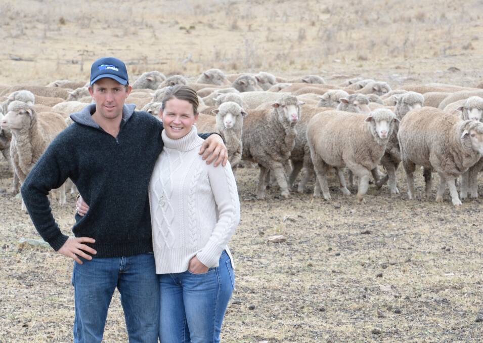 Gavin Swords and his partner, Carina Bunting, "Laraben", Mudgee, in a paddock of two- to five-year-old commercial flock ewes. They normally shear in March and hope the market stays strong until May/June when they sell their wool.