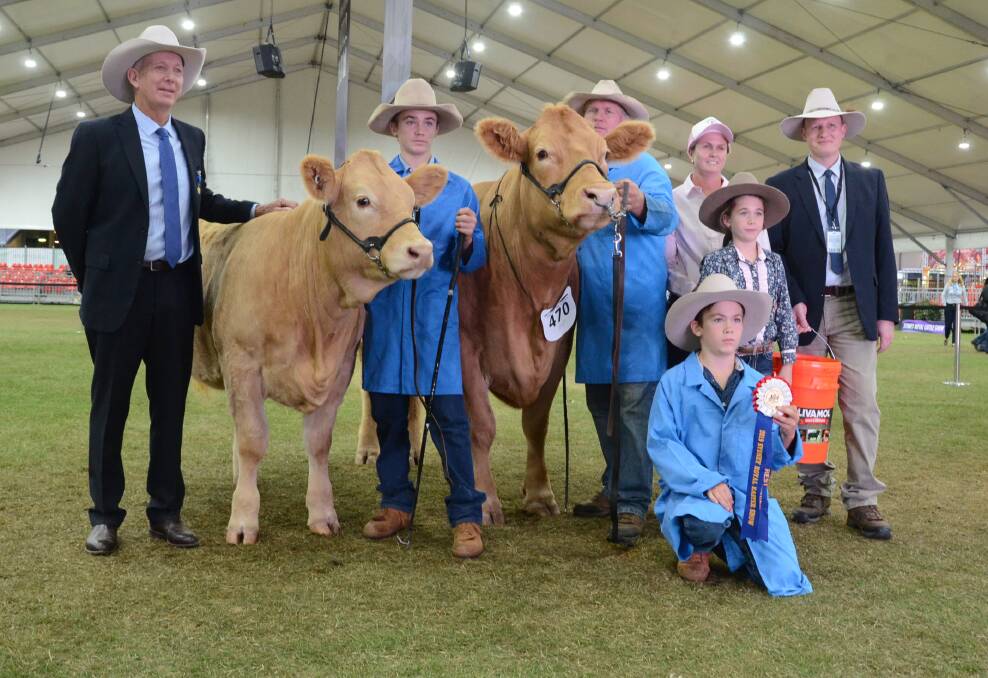 Best exhibit and grand champion Charolais female for the second successive year, Moongool Fanmail 8 (R/F), shown by the the Price family's Keddstock Pty Ltd, Moongool stud, Yuleba,Qld, with Judge, David Smith, Ben Lomond, Iva Price holds heifer calf while Ivan Price holds Fanmail with wife, Helen and children Tori and Hunter.
