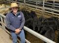 Kevin Miller, Whitty, Lennon and Company agent Ryan Browne, Young, with 318kg nine- to 10-month-old Angus steers sold by his client Crowa Pastoral, Young, for $2160 a head at the Central Tablelands Livestock Exchange, Carcoar, store cattle sale on Friday.