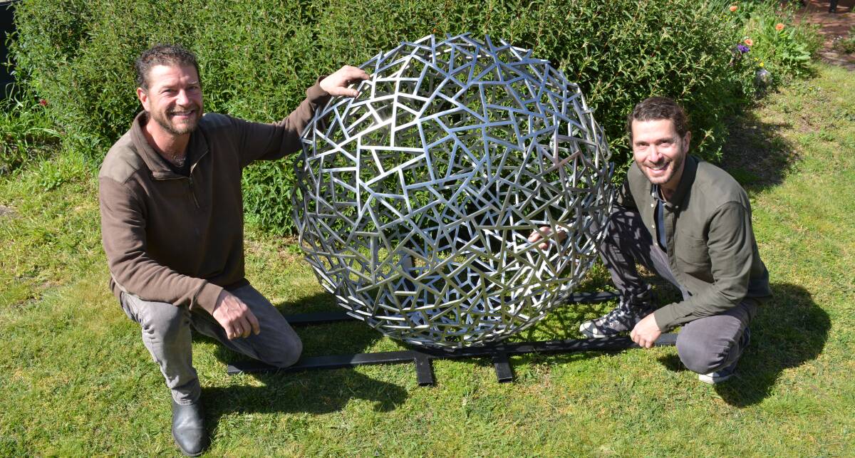 Carl and Eden Plaisted with their just painted sculpture, Flux, which will be on display at Sculptures in the Garden at Mudgee.