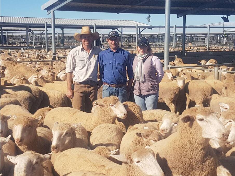 Forbes Livestock and Agency Company agent Randal Grayson with Matthew and Joanne Randall, Trundle, who sold lambs for $260/head at Forbes on Tuesday.