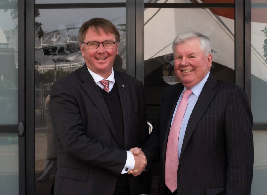Royal Agricultural Society of NSW new president John Bennett, Worrigee, is congratulated by outgoing president Michael Millner, Millthorpe. Picture supplied by Royal Agricultural Society of NSW.