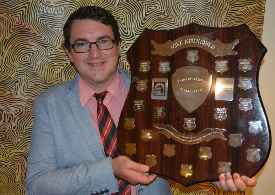 Elders agent Jake Kennedy with the Mike Nixon Shield for Excellence in Marketing.